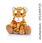 Small photo of Tiger plushie doll isolated on white background with shadow reflection. Playful bright brown puppy toy. Plush stuffed puppet on white backdrop. Fluffy toy for children. Cute furry plaything for kids.