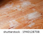 Small photo of Wooden floor deteriorated by water. The flooring is discolored white.