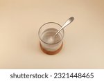 Small photo of Glass of Xanthan gum dissolved in water, top view. Food additive E415. Stabiliser and Thickener. Mixture is widely used in food industry for thickening gluten-free products, pastries and beverages.