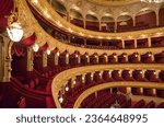 Small photo of Odessa, Ukraine - 09 04 2019: decor of the Odessa Opera House, interior of the theater in the Rococo style, boxes and tiers with chairs in the hall