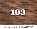 Small photo of Number 103 - piece on rustic wood background