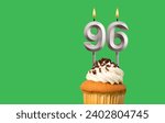 Small photo of Birthday card with candle number 96 - Cupcake on green background