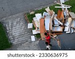 Small photo of Singapore Jun16 2021: A pile of dismantled furniture, kitchen cabinet shelves from renovation of HDB flat is disposed on sidewalk by irresponsible renovation contractors; debris and construction waste