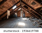 Attic room with clothesline, wooden trim and junk on the floor