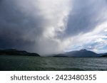 Small photo of Boats sailing on Lake Dillon I Colorado. Blue sky, blue choppy water with whitecaps on windblown water. Waves and sailboats with mountain backdrops.