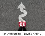 Small photo of Feet and white arrow sign go straight on road background. Top view of woman. Forward movement and motivation idea concept. Selfie of foot and legs in red sneaker shoes on pavement floor from above.
