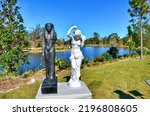 Small photo of New Orleans, LA, US- November 23, 2022: The Mete of the Muse, by Fred Wilson, in The Sydney and Walda Besthoff Sculpture Garden. African and European sculptures highlights bias in the world of art