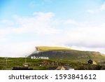 Small photo of Nolsoy island panorama with Nollywood sign on a hill. Faroe Islands, Denmark.