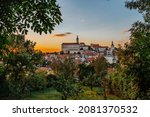 View of Mikulov with beautiful Baroque castle on the rock at sunset,south Moravia,Czech Republic.Dominant of town skyline.Czech Chateau in Palava wine region.Picturesque town among vineyards.