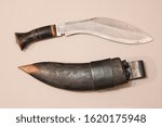 Small photo of Old original kukri knife used by the nepalese military corp of gurkhas, with a huge steel recurved blade, buffalo horn handle and leather sheath