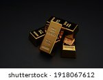 Small photo of A pile of gold bar a black background. Shiny precious metals for investments or reserves.