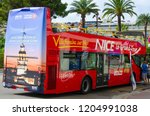 Small photo of NICE, FRANCE - SEPTEMBER 15, 2018: Unidentified tourists sit in red double-decker sightseeing bus (Nice Le Grand Tour) in city center, Nice, France