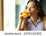 Happy woman drinking orange...
