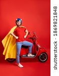Small photo of strong super hero man in cloak stand next to motorcycle, ready to conquer the world, isolated on red background