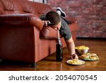 Fat Lazy Boy Taking Fries From Plate Lying On Sofa, Alone At Home, Teenager Boy Having Rest After School, Relaxed. Caucasian child lead unhealthy lifestyle, eating junk meal. overweight, obesity