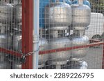 Small photo of old metal crate gas cylinder under lock and key, soft focus closeup photo, energy crisis