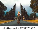 Tourist woman with backpack at vacation walking through the Hindu temple in Bali in Indonesia