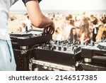 Small photo of Close up of deejay playing electronic music at summer beach party - Music festival and club party event concept