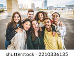 Multiracial group of friends taking selfie picture outdoors - Millennial people having fun on city street - International students smiling together at camera - Youth culture and community concept