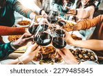 Small photo of Happy friends toasting red wine glasses at dinner party - Group of people having lunch break at bar restaurant - Life style concept with guys and girls hanging out together - Food and beverage