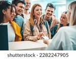 Small photo of Group of young people takes room key card at check-in of youth hostel guest house - Happy tourists talking with receptionist at hotel lobby - Summer vacations and tourism concept
