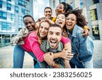 Small photo of Multi ethnic young people smiling together at camera outdoors - Happy group of friends having fun hanging out in downtown street - University students standing together in college campus