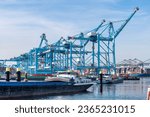 Small photo of Rotterdam, the Netherlands-September 16, 2023; Inland vessels in front of the SQCs (Super Quay Cranes) of the APM Terminal with large container vessels being loaded and unloaded