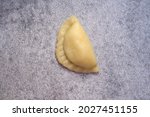 Small photo of Traditional Polish pierogi ruskie on a gray background.