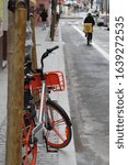 Small photo of Madrid, Cmd Madrid/Spain 12 09 2019, Dowtown Madrid street, old orange bike