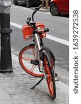 Small photo of Madrid, Cmd Madrid/Spain 12 09 2019, Dowtown Madrid street, old orange bike