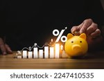Small photo of interest rates and dividends, investment returns, income, retirement Compensation fund, investment, dividend tax. pile of coins and upward direction percentage symbol. saving money for investment