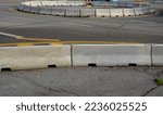 Small photo of horizontal road marking lanes. highway concrete barriers on the road. vehicle collision lane separator. yellow color with black stripes. the road roundabout concrete barriers