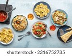 Pasta variety. Italian food and drinks, overhead flat lay shot. Spaghetti marinara, mushroom pappardelle, seafood pasta, wine, tomato sauce, Parmesan