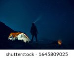 man standing beside camping... | Shutterstock . vector #1645809025