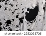 Small photo of old dirty ragged shirt with holes, grunge damaged cloth on black background, ripped white fabric with many holes
