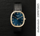 Small photo of Milan Italy_ November 9, 2023. old luxury watch, circa 1970, Ellipse model by Patek Philippe. dark background