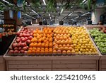 Various type of fresh fruits arrange neatly grocery store. Apple, Orange, Pomegranate, Lemon on rack. 