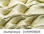 Frozen Pistachio flavour gelato - full frame detail. Close up of a creamy pastel green surface texture of Ice cream.