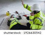 Small photo of Work accidents of worker in workplace at construction site area and Unconscious with colleague motion and call to the safety officer for rescue and Life-saving. Selection focus on an Injured person.