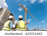 Construction engineers discussion with architects at construction site or building site of highrise building