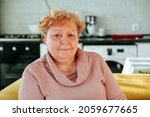 Small photo of portrait of an overweight elderly woman looking at camera. problems with extra kilograms in people