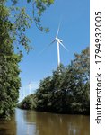 Small photo of Wieringerwerf, Noord-Holland/ Netherlands - 8-8-2020: three of the four windmills in forest Robbenoordbos, part of Windpark Wieringermeer, the biggest windmill park in the Netherlands till now
