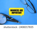 Small photo of magnifying glass, glasses, pen and colored paper with the words manners are important. about discipline or manners