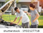 Small photo of asian elderly husband and wife couples lose temper broken car have a problem on the road. man trying fix their car with woman scolding reproach.
