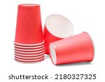 There are the red paper cups on a white background. It is the stack of plastic cups. It is isolated view of pink disposable glass.