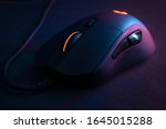 Small photo of Gamer mouse, with contrasting lighting and colors that refer to technology
