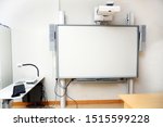 Interactive whiteboard with beamer as a modern school blackboard in the classroom, copy space