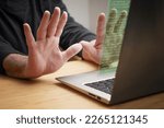 Small photo of Hands recoil in stop gesture from the laptop computer, as unknown code appears on the screen, concept of cybercrime like hacking attack, ransomware and other online risks, copy space, selected focus