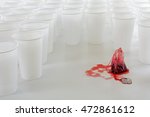 Small photo of teabag with red hibiscus tea beset by a group of white plastic cups, abstract concept of social issues such as burnout, unrealizable expectations and fail fear