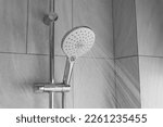 Small photo of Close up shower head in modern bathroom with water drops flowing.Sanitary ware for bathroom interior.Running water of shower faucet.Fresh shower behind wet glass window with water drops splashing.